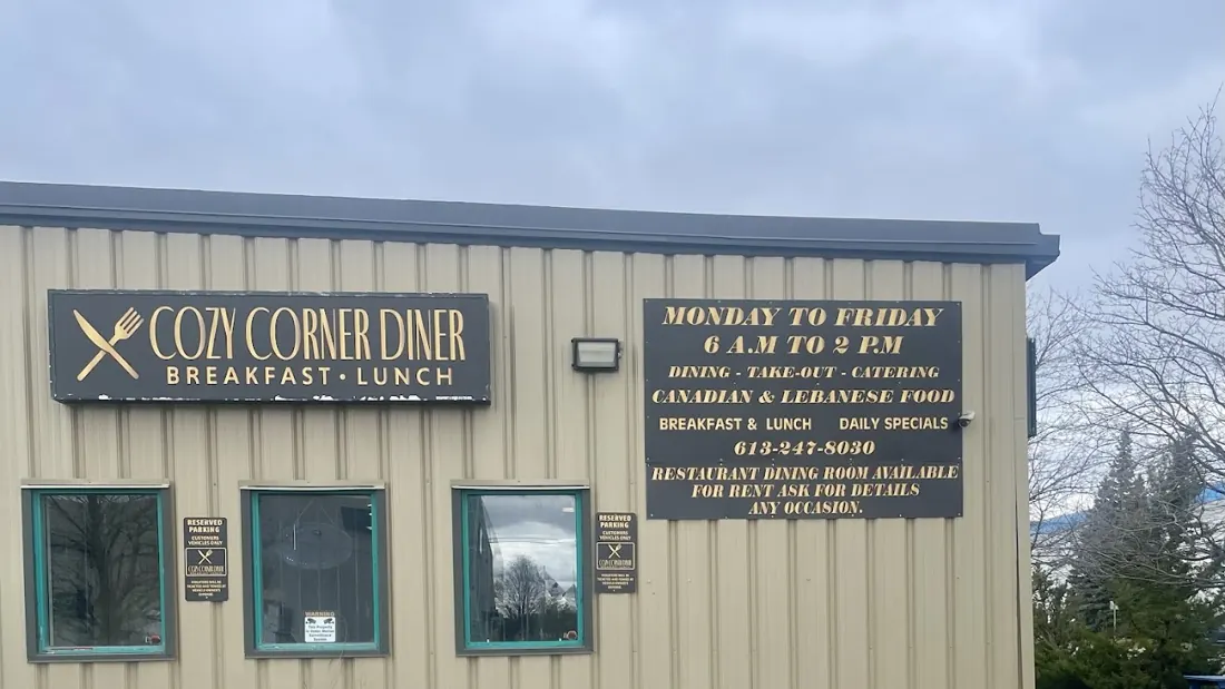 Cozy Corner Diner building with a green sign reading Cozy Corner Diner, Breakfast and Lunch