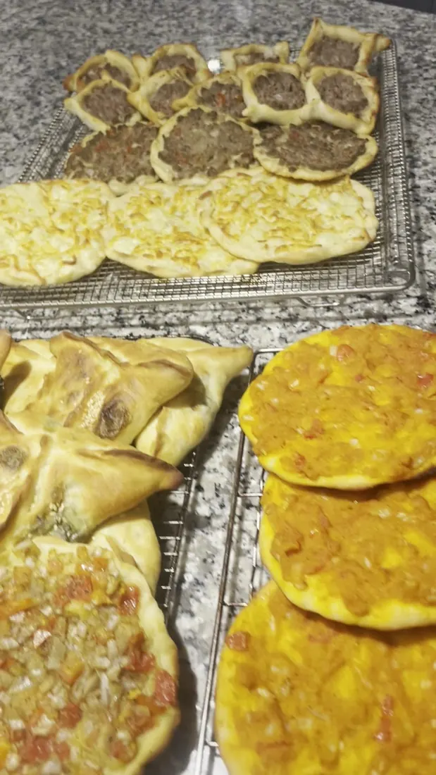 Tray of baked Lebanese-style flatbreads and pies